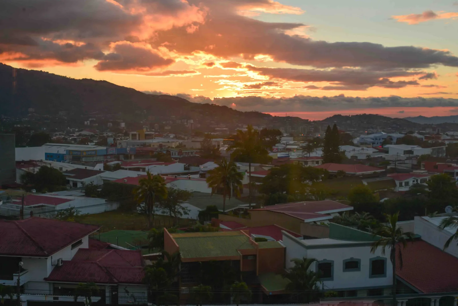 Sunset over the rooftops and mountains of San José